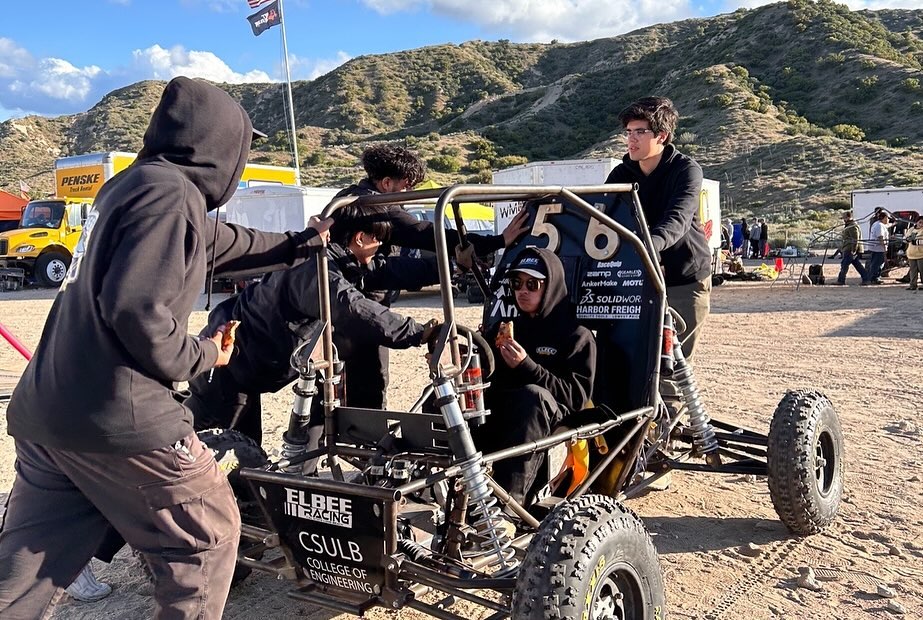 Baja car pit prep on a desert test day